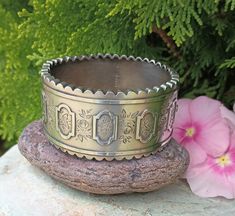 "Stunning Antique Sterling Silver bangle bracelet. This Victorian Bracelet has scalloped outer edges and is just one of the many beautiful details on this Bracelet. Engraved with Ivy leaves, Vines and Roses, with 5 raised decorative Design. It must have been given for a special occasion. Ivy leaves symbolized a union for eternity such as marriage or friendship, because the ivy plant grows upward and bonds to whatever it attaches to. It is stamped Standard Silver, J H, With the Birmingham Anchor Symbol, The England Lion Symbol for Sterling Silver and another mark see pictures for details. These Antique Bracelets with scalloped edges are not very common as those with straight edges or the beaded edges. These pieces were not mass produced, and each piece is truly a beautiful work of art.  The Lion Symbol, Anchor Symbol, Ivy Plant, Victorian Bracelet, Ivy Leaves, Antique Bracelets, Sterling Silver Bangle Bracelets, Ivy Leaf, Satin Bags