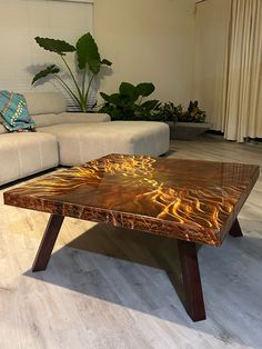 a coffee table sitting on top of a hard wood floor next to a white couch