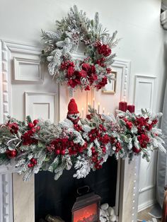 a fireplace decorated for christmas with red and silver decorations