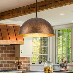 a kitchen with an island and brick wall