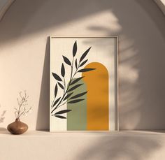 an art print is displayed on a shelf next to a vase with a plant in it