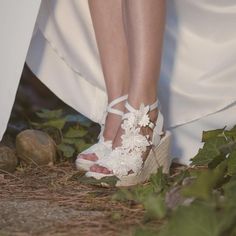 a close up of a person's feet wearing wedding shoes