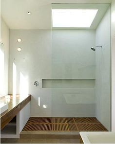 an empty bathroom with a skylight above the bathtub and shower stall in it