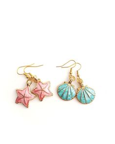 Sea shells/beach theme earrings in bright pretty colors! Pink starfish or blue shells with s shiny gold color as the base of the charms. Both earrings measure about 1.75 inches in length from top to bottom. Very cute & fun charm earrings, definitely eye-catching! Reminds me of what a mermaid might wear! Cheap Colorful Earrings For The Beach, Gold Starfish Shell For Beach, Gold Dangle Earrings For Beach Season, Summer Starfish Charm Dangle Earrings, Summer Dangle Earrings With Starfish Charm, Beachy Gold Dangle Earrings, Gold Earrings For Beach Season, Summer Starfish Charm Drop Earrings, Ocean-inspired Shell With Starfish Charm For Summer