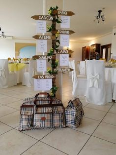 there are many bags on the floor in front of a table with white linens