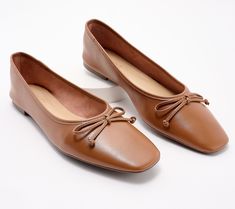 a pair of women's brown shoes with laces