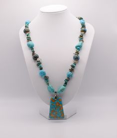 "Necklace with Turquoise, Chalk Turquoise, Smokey Quartz, Magnesite, Ceramic Beads, Focal, mosaic \"turquoise\" (magnesite) (dyed / assembled), blue, 40x29mm-40x30mm top-drilled trapezoid, Antique Silver Plated Toggle, 19.5\"" Artisan Turquoise Amazonite Jewelry, Turquoise Blue Necklace With Natural Amazonite Stones, Turquoise Amazonite Polished Beads Necklace, Turquoise Amazonite Necklace With Polished Beads, Artisan Turquoise Jewelry, Handmade Turquoise Chrysocolla Necklace, Turquoise Necklace With Gemstone Beads For Healing, Handmade Blue Amazonite Beaded Necklaces, Blue Chrysocolla Necklace With Stones