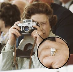 a woman taking a photo with an old camera in front of her face and the ring on her finger