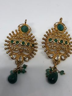 Vintage Indian wedding style button stud earrings Main stone Green emerald and white sapphire Over an inch long Lovely handmade silver work with gold finish 92.5% Sterling Silver All jewelry is shipped in a nice gift box. Check out our over a THOUSAND great reviews Traditional Jeweled Gold-plated Earrings, Handmade Round Emerald Earrings, Elegant Green Earrings With Intricate Design, Green Gold-plated Earrings For Wedding, Green Gold Plated Bridal Earrings For Wedding, Green Hand Set Earrings For Gift, Green Gold-plated Bridal Earrings For Wedding, Green Hand-set Earrings For Gift, Green Jeweled Dangle Earrings