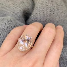 This one of a kind rose gold ring features a beautiful, hand selected blushing morganite, haloed with diamonds. Center stone measures approximately 16mm by 12mm Morganite is the stone of love and compassion - it is a wonderful choice for alternative brides. This ring is a size 6, but can be resized to most standard sizes prior to shipping. All resized rings are final sale. Total morganite weight: 8.87ct Total diamond weight: 0.21ct SKU: RK010056R17-R-WDMG-6 Exquisite Morganite Diamond Ring For Anniversary, Exquisite Morganite Rose Gold Rings, Exquisite Rose Gold Morganite Ring, Exquisite Morganite Rings, Exquisite Formal Morganite Ring, Formal Fine Jewelry Blush Rings, Morganite Diamond Ring With Accent Stones, Elegant Morganite Cushion Cut Rings, Timeless Morganite Ring With Center Stone