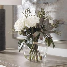 a vase filled with white flowers on top of a table