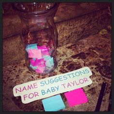 a jar filled with lots of colorful sticky notes next to a name tag that says name suggestions for baby taylor