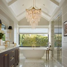 a bathroom with a large tub and chandelier