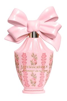 a pink perfume bottle with a large bow on the top that says loveshack fancy