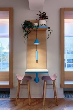 two stools and a table with plants on it