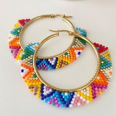 two pairs of hoop earrings with multicolored beads