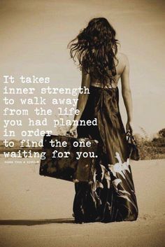 a woman with long hair walking down the beach holding a bag and looking at the ocean