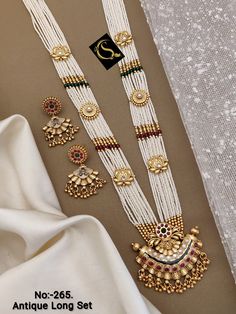 Description :- Indian Jewelry Necklace Set/ South Indian Necklace / Bollywood Ethnic Copper Necklace Earring Set/ Southindian Gold Plated Necklace Set Gift yourself a royal look with this perfectly crafted kundan necklace set from Manalisstudio. Crafted with high quality kundan stones and pearls, it is impressive in design. The green enamel artwork adds perfect texture to the design. Perfect for weddings and festivities, this antique necklace set should be put on with your favorite sari or lehen Traditional White Kundan Necklace With Latkans, Traditional White Jewelry For Festivals, Traditional White Cutdana Jewelry Sets, Traditional White Jewelry With Cutdana, White Temple Jewelry With Motifs, Traditional White Cutdana Jewelry, Indian Jewelry Sets Gold, Heavy White Jewelry For Navratri, White Chandbali Jewelry For Navratri