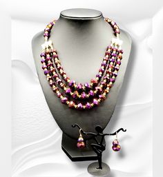 "Purple Radiance": This Purple Radiance Necklace illuminates any neckline with vibrant, iridescent color. Crafted from sparkling, jewel-inspired stones, this piece is sure to become a conversation starter, infusing your ensemble with luminous charm and grace. Necklace is approximately 19" with extender. Purple Round Beads Jewelry For Festive Occasion, Purple Beaded Jewelry For Festive Occasions, Purple Faceted Beads Jewelry For Party, Purple Jewelry With Faceted Beads For Party, Adjustable Purple Jewelry For Party, Purple Crystal Jewelry Set For Party, Purple Round Beads Jewelry For Party, Adjustable Purple Crystal Jewelry, Iridescent Adjustable Necklace For Party