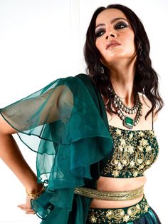 A four-piece Green Meesha Marble lehenga set from the Rashika Sharma collection. This classic green chiffon bustier blouse has a back hook opening with straps. It is paired with a chiffon marble printed lehenga. The lehenga features an embroidered belt detail at the waistline. There is embroidery on the bustier with beads, zari, sequins, and thread work. This outfit is completed with an organza-chiffon ruffle green dupatta and a gold chiffon sequins belt.
Potli Bag NOT included. Sequins Belt, Bustier Blouse, Green Dupatta, Printed Lehenga, Potli Bag, Embroidered Belt, Wedding Branding, Ghagra Choli, Potli Bags