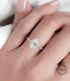 a woman's hand with a diamond ring on it