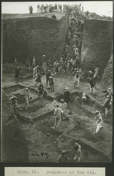 an old black and white photo of people standing in the dirt