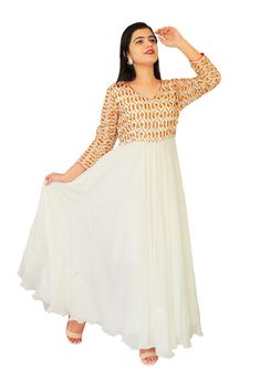 This gorgeous embroidered White Chinon Dress is a good pick for any upcoming occasion , Phulkari multi-color embroidery & golden sequins work 3/4 sleeves, Perfect for ethnic festivals, Parties and other occasions! Product Code: ACK21361 Fabric: Pure Chinon & fine quality santoon for lining Stitching: Fine tailored  Size Info.:  Sleeves- 17",  Chest- 40",  Waist- 36" to 38" (half elastic),  Length- 52" Washcare: Dry clean recommended Message: You can also buy a matching scarf from our collections. Feel free to contact us for queries. Note: Product color may slightly differ from the image. Please note the we offer expediate shipping, that only speeds up the shipping time, our processing time will not be effected. Anarkali Dresses With Embroidered Neckline For Festive Occasions, Festive Anarkali Dress With Embroidered Neckline, Anarkali Dresses With Embroidered Neckline For Festive, Anarkali Kurta With Embroidered Neckline Maxi Length, Anarkali Style Maxi Kurta With Embroidered Neckline, Anarkali Style Kurta With Embroidered Neckline, Festive Straight Kurta Dress With Embroidered Neckline, White V-neck Dress With Resham Embroidery, Fitted Anarkali Kurta With Embroidered Neckline