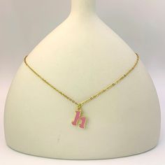 Add a touch of personality and whimsy to your look with our Personalized Pink Initial Necklace. This charming necklace features a custom letter of your choice, crafted with a gold-plated finish and filled with vibrant pink enamel. The delicate chain complements the playful letter, creating a cheerful and eye-catching piece. Perfect for everyday wear or as a gift, this necklace is a delightful way to express your unique style. Personalized Enamel Charm Necklaces For Gifts, Personalized Gold Enamel Charm Necklace, Pink Pendant Charm Necklace, Enamel Initial Pendant Jewelry Gift, Pink Pendant Charm Necklace For Birthday, Personalized Pink Charm Necklace As Gift, Pink Necklace With Adjustable Chain For Her, Trendy Pink Gold Plated Jewelry, Trendy Pink Gold-plated Jewelry