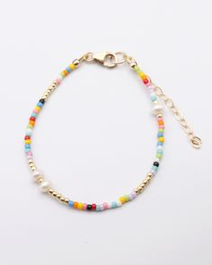 the multicolored beaded bracelet is shown with gold beads and an adjustable clasp