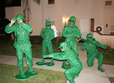 some people in green costumes are playing with each other