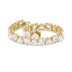 a yellow gold bracelet with heart shaped diamonds