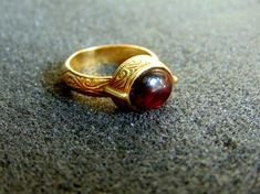 Beautiful women's engraved statement ring. It is made completely out of 18k gold (aka gold 750 each piece is stamped), with a stunning oval garnet stone in its center...------> If you do not know, or you are not sure about your ring size, the ring will be adjustable<----------->A useful guide to help you determine your ring size: http://www.ringsizes.co/ <------ Byzantine Jewelry With Cabochon For Gifts, Byzantine Cabochon Jewelry For Gifts, Byzantine Style Cabochon Jewelry For Gifts, Byzantine Style Cabochon Jewelry Gift, Antique Dome Ring With Polished Finish As Gift, Heirloom Signet Ring With Cabochon As A Gift, Heirloom Signet Ring With Cabochon For Gift, Antique Dome Ring With Polished Finish, Antique Polished Dome Ring Gift