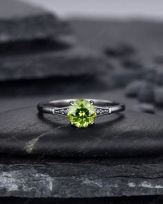 Gemstone can be replaced with other birthstone, if you would prefer a custom ring, please contact us. Rhodium black engagement ring like no other. This AMAZING piece of fine jewelry is the perfect expression of your eternal love. Its BLACK colors bring out the beauty of this ring. ★Description *Center stone: 1.2 Carat, 6 mm Round Shape Natural Peridot *Accent stone:  Black Moissanite *Band Width(Bottom): 1.7mm ★Procedure information Please select the material and ring size from the drop-down men Peridot Birthstone Ring For Promise Occasion, Peridot Birthstone Ring For Promise, Green Diamond Birthstone Ring With Accent Stones, Lime Green Peridot Ring For May Birthstone, Lime Green Peridot Birthstone Ring For May, Lime Green Birthstone Jewelry For Anniversary, Anniversary Lime Green Birthstone Jewelry, Green Sapphire Ring With Accent Stones For Promise, Green Sapphire Promise Ring With Accent Stones