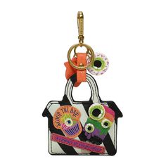 a key chain with an owl and cupcake design on the front, hanging from a metal hook