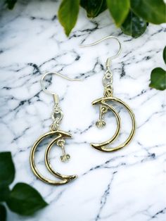 Crescent moon Dreamland Earrings 🌙 Free shipping! The moons have a slight rose gold tone, although they look pretty close to silver as well. They come with silver earring hooks, but I'm happy to add on gold hooks instead! Send me a message & let me know if you have a preference. Crafted with love 💖   Thank you for checking out LunaeLumina!  Feel free to message me if you have any questions! Gold Moon-shaped Metal Hoop Earrings, Gold Moon Shaped Metal Hoop Earrings, Gold Moon Shaped Hoop Earrings, Rose Gold Celestial Earrings, Crescent Silver Earrings As Gift, Nickel-free Moon-shaped Hoop Earrings, Nickel-free Moon-shaped Metal Hoop Earrings, Silver Moon-shaped Metal Hoop Earrings, Celestial Gold Crystal Earrings Nickel Free