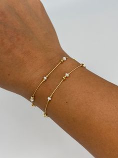 A dainty take on a pearl bracelet. Gold beads float freely in between dainty pearls. 1" extender 14k gold fill made in Los Angeles pearls vary in shape and size Sizes Small - 15cm or 6" Medium - 16cm or 6.5" Large - 17cm or 7" Dainty Pearl Bracelets With Tiny Beads, Minimalist Gold Pearl Bracelet With Delicate Chain, Minimalist Adjustable Beaded Bracelet With Pearl Chain, Minimalist Adjustable Beaded Bracelets With Pearl Chain, Dainty Gold-plated Bracelets With Pearl Charm, Delicate Gold Chain Bracelet With Pearl Charm, Dainty Gold Plated Bracelets With Pearl Charm, Dainty Gold Bracelets With Pearl Chain, Adjustable Pearl Bracelet With 14k Gold Filled Round Beads