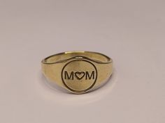 About item:-Personalized Engraving Mom Ring Materiel:- 925 Sterling silver Purity:- 92.5 Title:-Mom heart Signet Ring, 10k Gold Mama Ring, Gold Engraved Signet Ring, Gold Stacking Ring, Gifts for Mom, Mother's Day Gift, Christmas gifts, Valentine Day gift, Engagement ring, Anniversary ring,  Gift for women's, Dainty ring, Gift for him & her, Promise ring, Proposal ring, Birthday gift,  - Choose your size in the variation at check-out! - All rings comes in jewel bag. Benefits of wearing silver:- Wearing silver jewelry is proved in fighting infection and preventing yourself from cold and flu, and many kinds of bacteria and viruses. Silver helps expand blood vessels elastic. This condition makes it possible for the quick formation of bones and healing of the various parts of body from wound t Symbolic Gold Heart-shaped Ring, Symbolic Heart Shaped Rings As Gifts, Heirloom Heart-shaped Signet Ring For Gift, Heirloom Heart-shaped Signet Ring As Gift, Gold Signet Ring For Valentine's Day Stamped 14k, 14k Stamped Signet Ring For Valentine's Day, Vintage Rings With Hallmark As Gift, Symbolic Hallmarked Signet Ring Gift, Round Engraved Ring With Hallmark For Anniversary