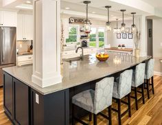 a large kitchen with an island in the middle and lots of counter space on one side