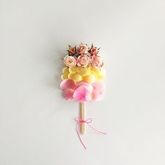 a lollipop with flowers on it sitting on a stick