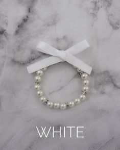 This item is FINAL SALE. No exchange or refund. Elegant elastic ivory pearls bracelet with beads and clear rhinestones with satin ribbon bow. Available is Silver and Gold beads in between pearls.This listing is only for 1 bracelet. Great for bride, bridesmaids, flower girls gift to wear on the wedding day.Bracelet is measured to approximately 7 - 8 inches, however, it can stretch to match wrist larger due to the the elastic. Bracelet With Beads, Pearls Bracelet, Satin Ribbon Bow, Flower Girl Gifts, Ivory Pearl, Girls Gift, Satin Bow, Flower Girls, Ribbon Bow