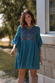 Bring a touch of playful elegance to your wardrobe with the Whimsical Teal Floral Embroidered Mini Dress! With its delicate details and flowy silhouette, this dress is perfect for any occasion that calls for a little fun and flirtation. Designed with airy bell sleeves, this dress offers a romantic and free-spirited feel. Featuring beautiful floral embroidery, this dress brings a whimsical, boho charm to your look. Pair it with your favorite boots for an effortlessly chic look that's ready for any adventure. Summer Embroidered Mini Dress For Garden Party, Embroidered Mini Dress For Summer Garden Party, Chic Embroidered Mini Dress For Beach, Embroidered Midi Mini Dress For Summer, Elegant Embroidered Bell Sleeve Dress, Elegant Bell Sleeve Embroidered Dresses, Chic Floral Embroidered Mini Dress, Chic Floral Embroidery Dresses For Brunch, Chic Floral Embroidered Dresses For Brunch