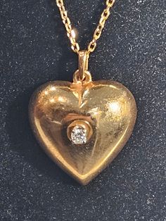 Heart  vintage 14K Gold chain and  heart pendant with  center diamond  Stone diamond 0.10 carats Chain signed 585 14K gold  Chain length 18 inches Total weight 8.7 gramms 14K  Shiny  amazing  One of a kind ! Vintage Yellow Gold Heart Charm Necklace, Vintage Yellow Gold Heart Necklace, Vintage Yellow Gold Heart Necklace For Valentine's Day, Antique Heart-shaped 14k Gold Necklace, Antique Yellow Gold Heart Necklace, Formal Diamond Necklace With Heart Pendant, Antique Heart Shaped Necklace For Anniversary, Antique Heart-shaped Necklace For Anniversary, Antique Heart Necklace For Anniversary