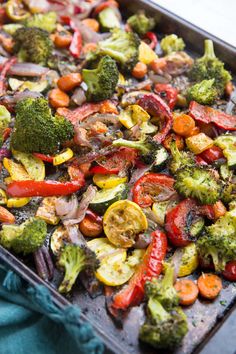 broccoli, red peppers and other vegetables on a baking sheet