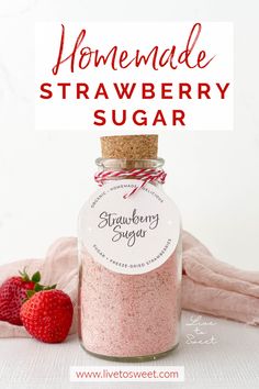 homemade strawberry sugar in a jar with strawberries next to it