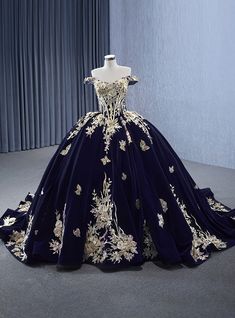 Xenodochial elegance is embodied in this majestic prom gown, inviting admiration and wonder from every onlooker! It features a luxurious velvet fabric in deep navy, adorned with golden botanical embroidery that blooms from the bodice down to the hem. The fitted bodice cinches in at the waist, showcasing a flattering silhouette, while the embroidery creates an illusion of opulence and depth. The gown's skirt billows out into a full circle, trimmed with a sweep train that adds a touch of drama with every step. This dress isn't just a piece of clothing; it's a wearable piece of art that promises to make any prom night an event of unparalleled sophistication and charm. Dark Blue Royal Dress, Gown For Debut, Navy Blue Ball Gown, Navy Blue Prom Dresses, Gown Skirt, Prom Inspiration, Quinceanera Dresses Blue, Quinceñera Dresses, Quince Dress