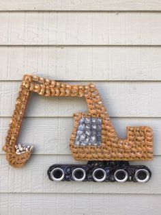 this is an image of a construction vehicle made out of plastic beads and chains on the side of a house