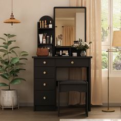 a dressing table with a mirror, stool and potted plant in front of it