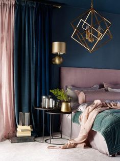 a bedroom with blue walls, gold accents and a pink headboard on the bed