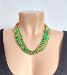 Kelly Green , Gold Multistrand Boho, Seed Bead Statement Necklace, for her, green necklace, bohemian necklace, beaded necklace The size shown on the model is 18". Please read specifications on SIZES below: ###SIZES This item comes in several sizes, kindly choose at checkout. The easiest way to find out which length suits you best is to measure a necklace you already own, from one end to the next, including clasp. You can also use the diagram on the pictures as a reference, but keep in mind that Handmade Green Bohemian Beaded Necklaces, Green Long Beaded Necklaces With Faceted Beads, Green Beaded Long Necklace With Faceted Beads, Green Multi-strand Wooden Beads Jewelry, Green Multi-strand Beads For Gifts, Green Long Beaded Necklace With Faceted Beads, Green Long Necklace With Faceted Beads, Green Multi-strand Beaded Necklace As Gift, Multi-strand Green Large Beads