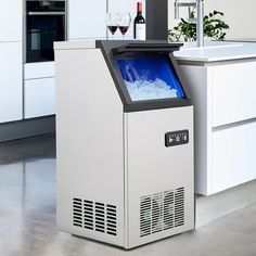 a white cabinet with a blue screen on the front in a kitchen next to a sink